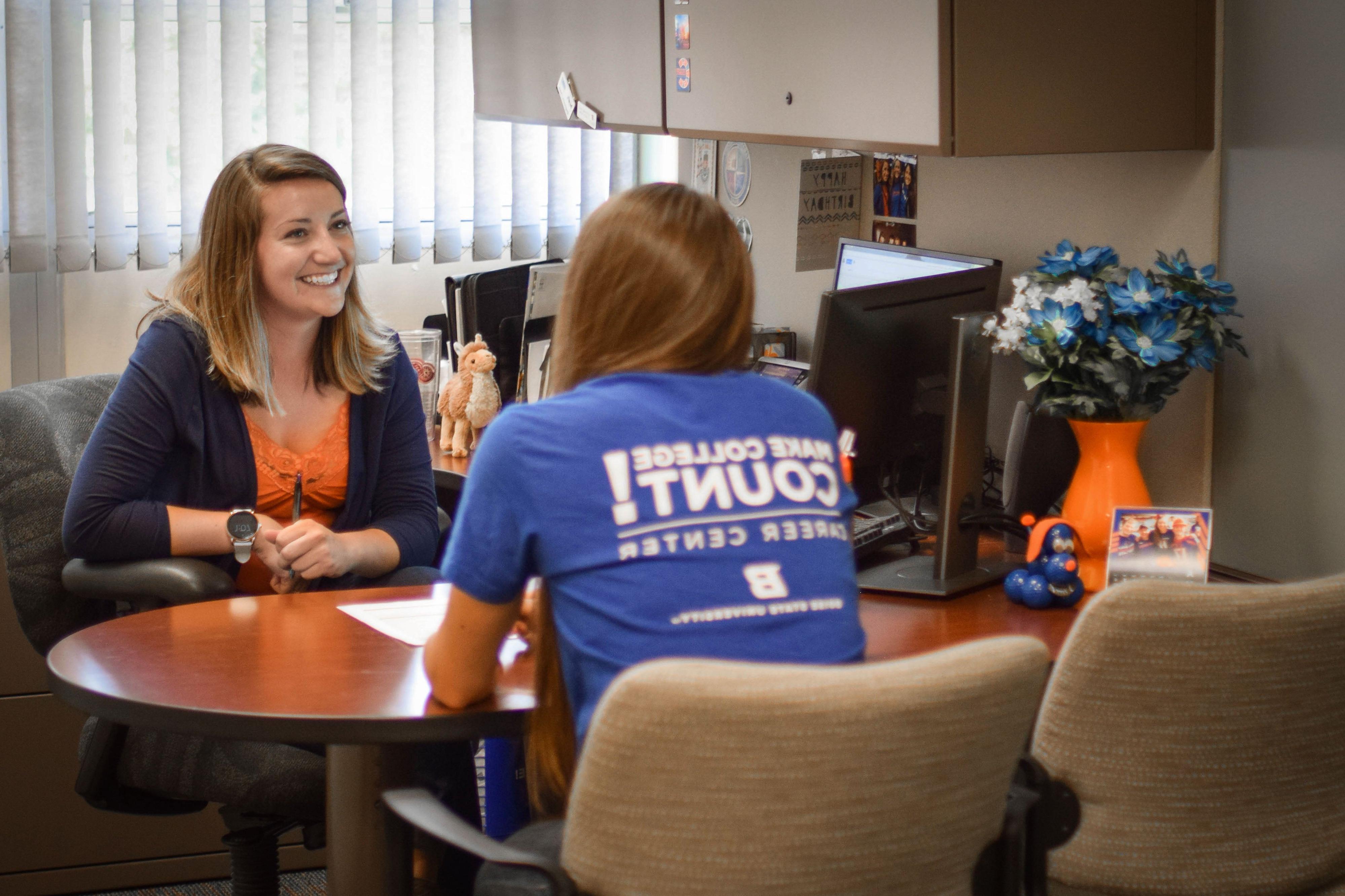 Student meeting with career counselor in an office